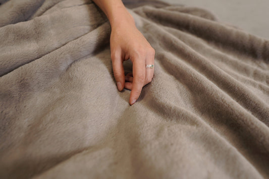 Woman's hand on bed