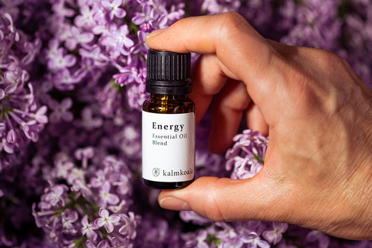 Person holding a bottle of essential oil